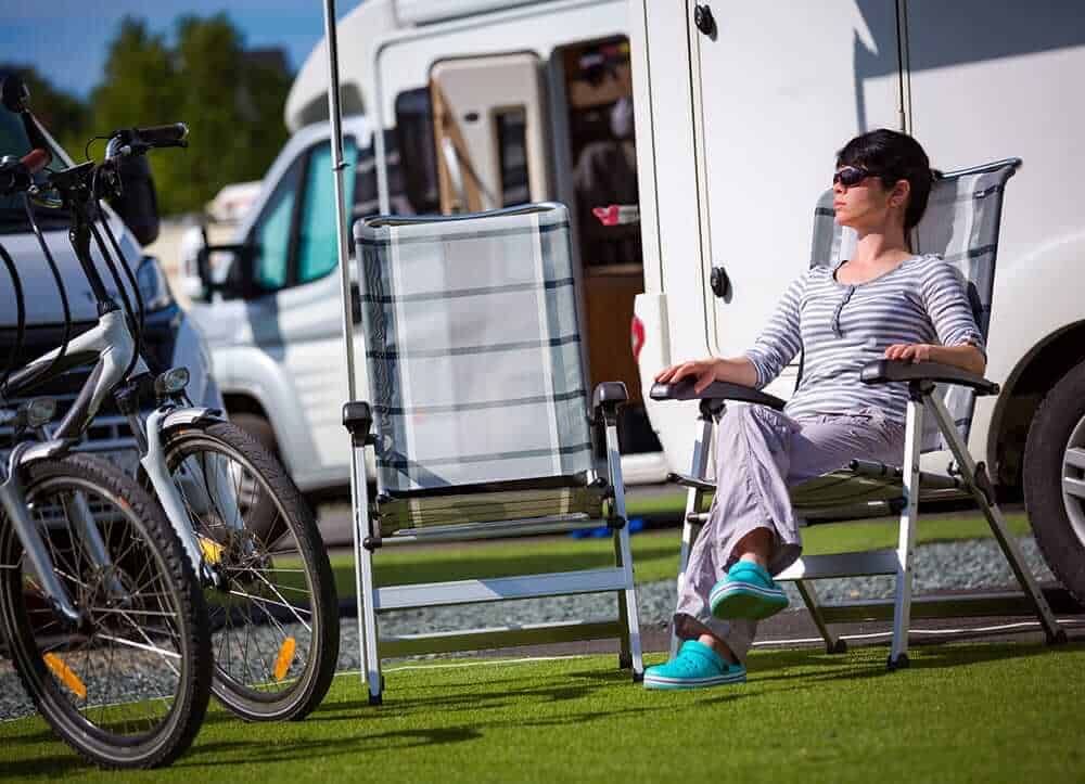 woman is sitting on a camping chair