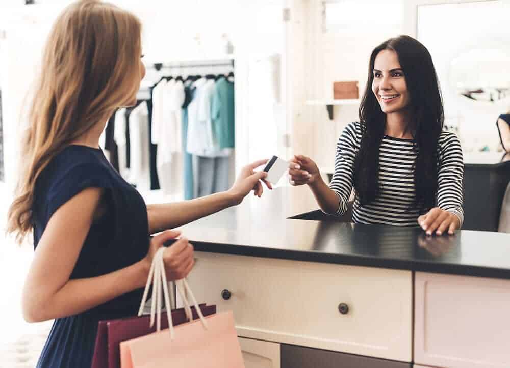 Girl pays for her retail shopping