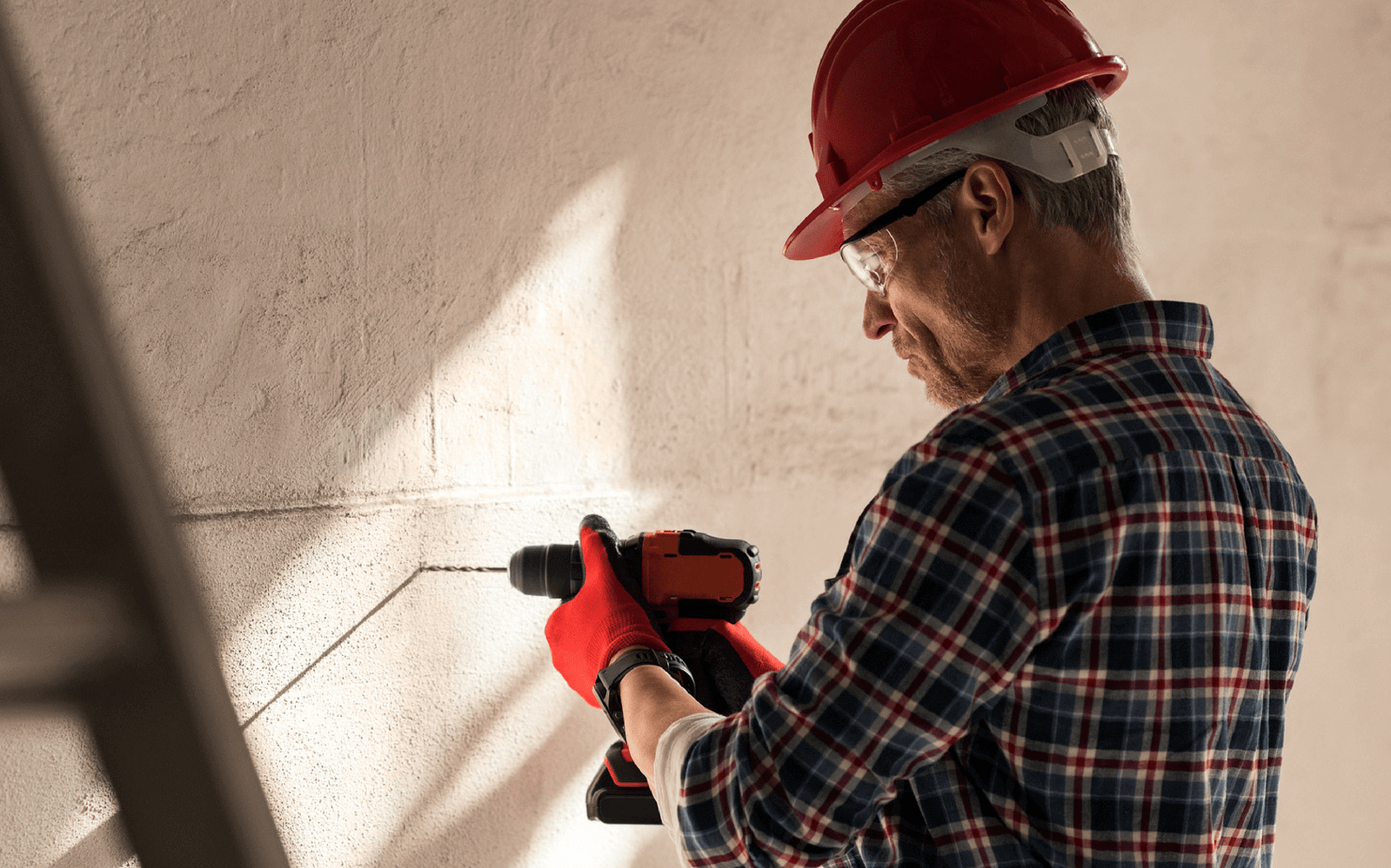 Man drilling brick wall